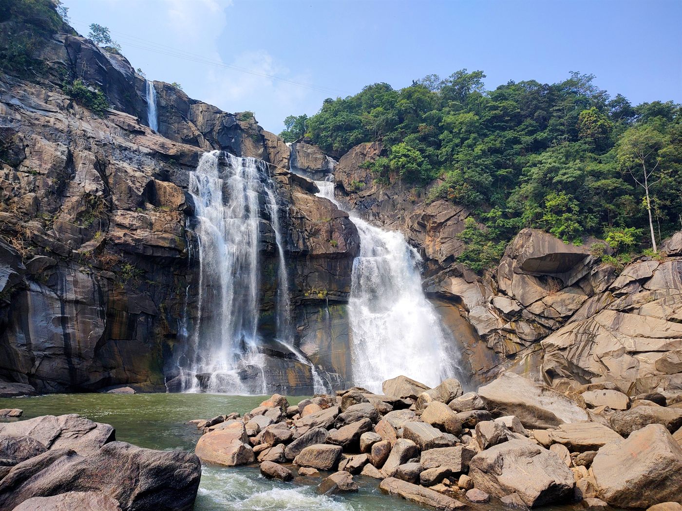 Hundru Falls in Ranchi district, where the Subarnarekha river drops over rocky terraces into a pool below.